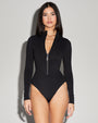 Model wears Surfy - Black One Piece Long Sleeve Shapewear Swimsuit full front view open zipper