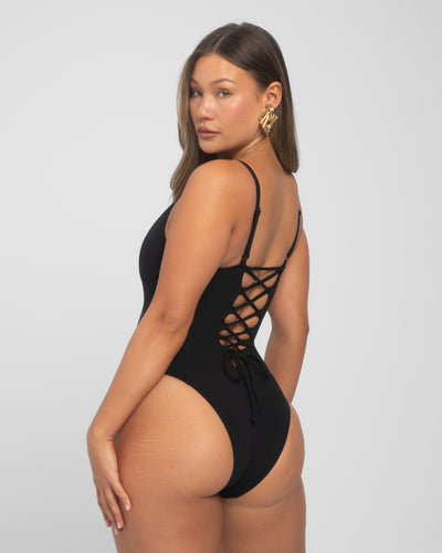 Model wears Brazilian Plungey Cheeky One Piece Shapewear Swimsuit - Black side view