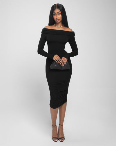 Model is posing in Shapey Off Shoulder Ruched Midi Shapewear Dress - Black