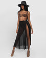 Model wears Ringy Sheer Slit Skirty - Black Cover Up Midi Skirt, a bikini and a hat