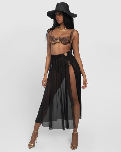 Model wears Ringy Sheer Slit Skirty - Black Cover Up Midi Skirt, a bikini and a hat