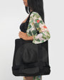 Model is posing with Totey Waterproof Spacious Bag with Hat Holder - Black side view