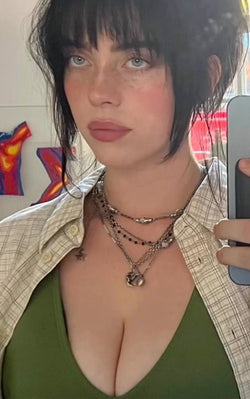 Billie Eilish taking selfie in plungey swimsuit by TA3
