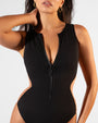 Zoomed in image of model in Brazilian Crewy - Contour Rib Black/Tawny with it zipped halfway down