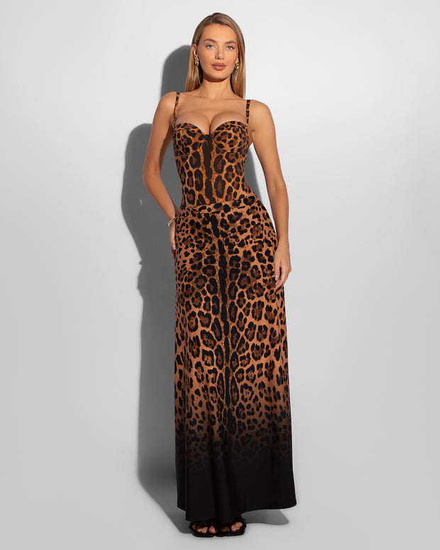 Model wears Brazilian Bombshell - Symmetric Leopard Shapewear Swimsuit with a matching skirt full front view