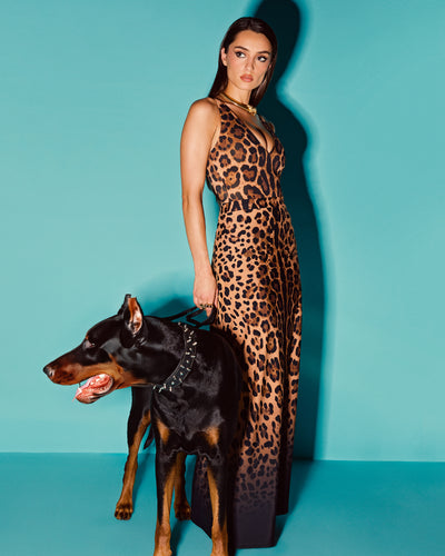 Model wears Brazilian Plungey Cheeky One Piece Shapewear Swimsuit - Symmetric Leopard and a matching skirt