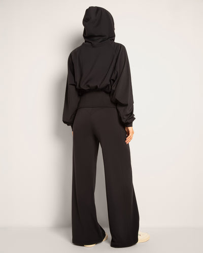 Full body back view of Cloudlined Corset Hoodie and Cloudlined Wide Leg Pant - Soft Black with hood on