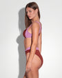 Model is wearing Lifty Shapewear Wide Strap Underwire Bikini Top - Copper/Lilac and matching swim top side view