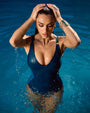 Model in the water is posing in Plungey - Wavy Ring Oceana Open Back One Piece Shapewear Swimsuit