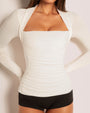 Model wears Shapey Ruched Long Sleeve Shapewear Top - Eggshell front view close up