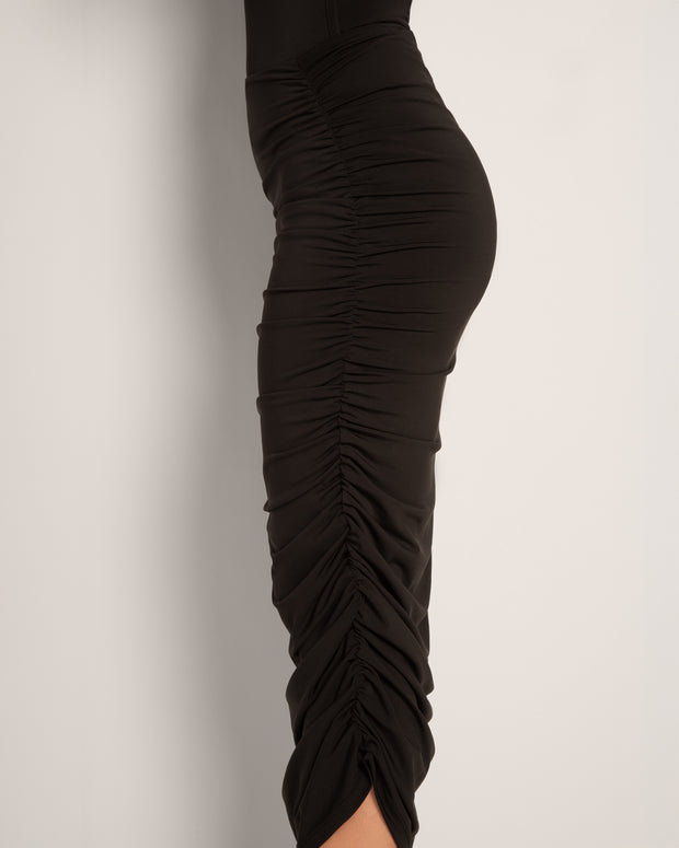 Model wears in Goddess Shaping Shapewear Midi Skirt - Black close up side view