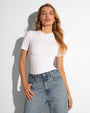Model wears Sculpty Short Sleeve Shapewear Tee - White front view tucked in