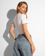 Model wears Sculpty Short Sleeve Shapewear Tee - White tucked in back view