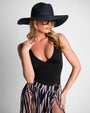 Model wears Shady Wide Brim Straw Full Sun Protection Hat - Black and one piece swimsuit