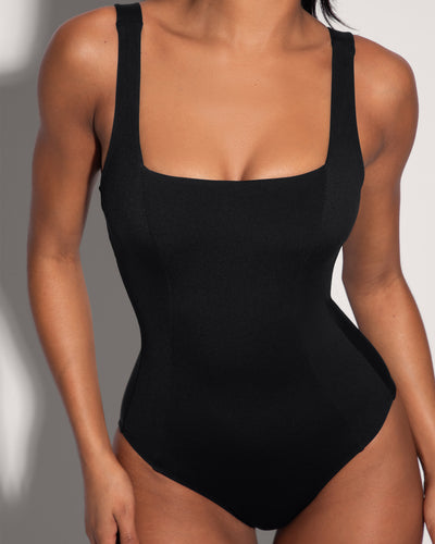 Model wears Squarey - Black One Piece Sculpting Shapewear Swimsuit close up front view