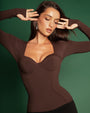 Model posing in Sweetie Long Sleeve Sculpting Shapewear Top - Espresso