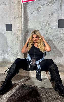 Bebe Rexha posing in Shapey Short Sleeve One Shoulder Top