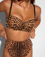 Close up of model wearing Brazilian Smoothing Kini Bottom - Symmetric Leopard paired with matching bikini top 