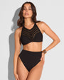 Model in Crochet Bikini Top - Black paired with a high cut bottom